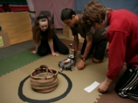 kids with robot in library room of the Mayan temple